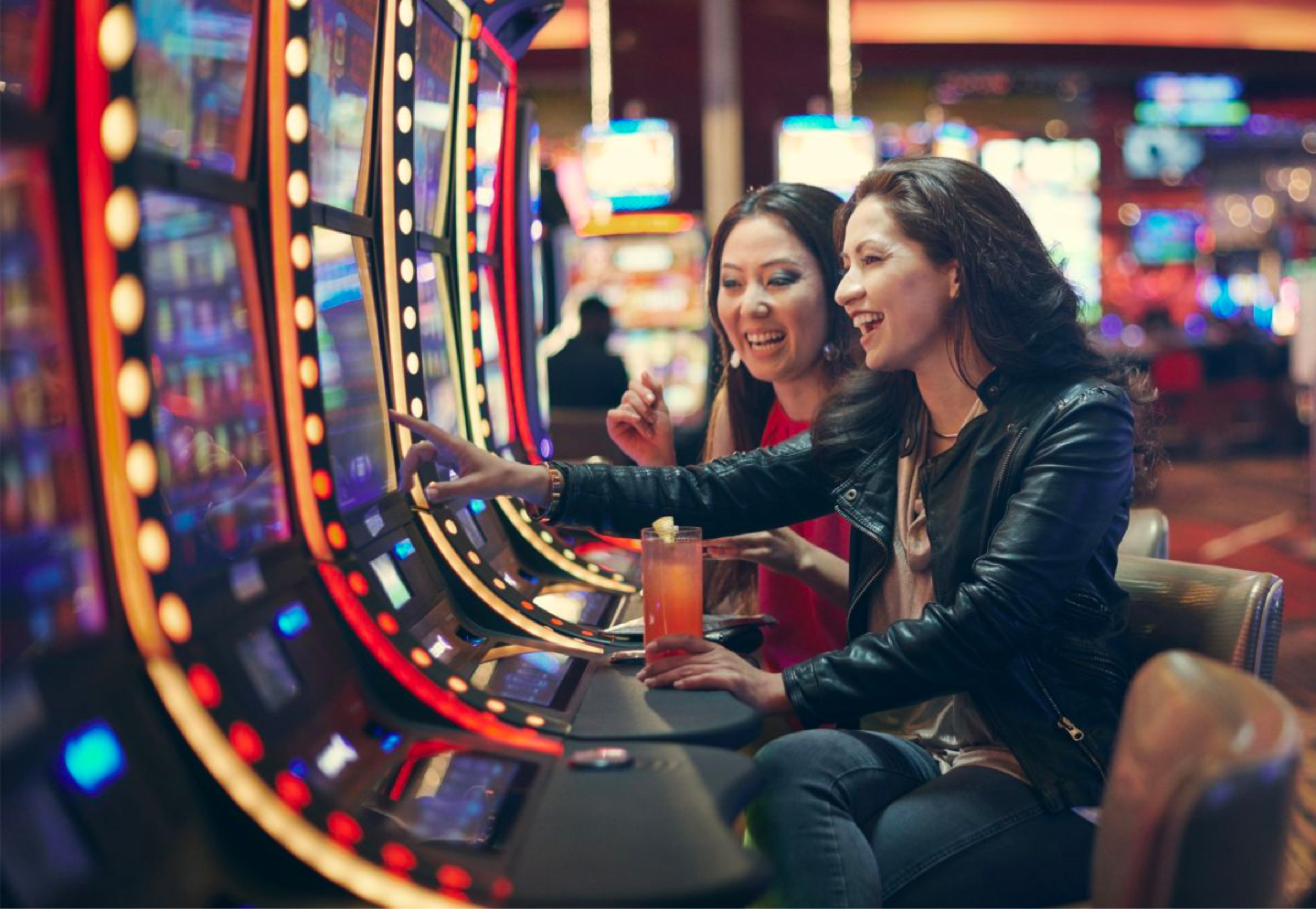 Two friends playing slots